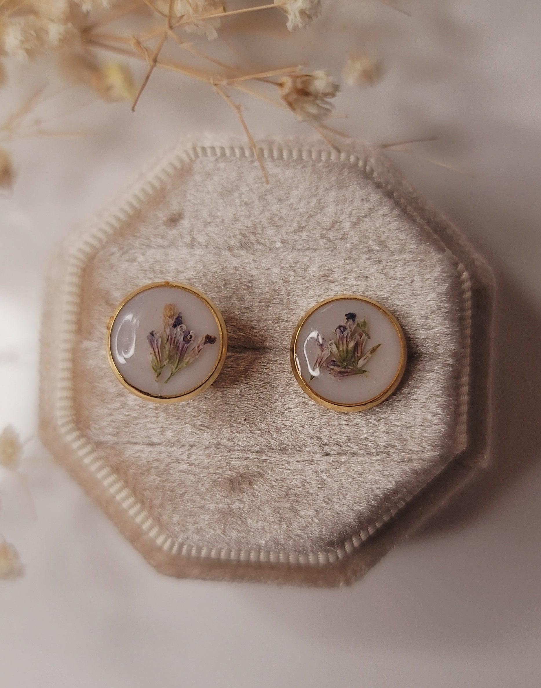 Decorative wall piece with two round mirrors on a textured beige background